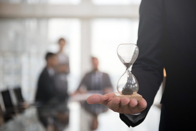 Businessman Holding An Hour Glass, Signifies The Importance Of Being On Time